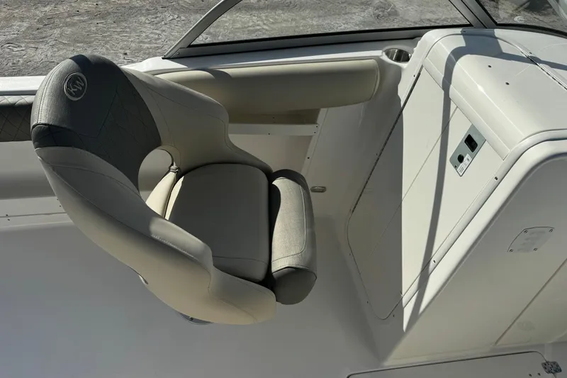 Slide: The Image of 2025 Key West 239 DFS boat interior with cushioned seating and control panel. - 12