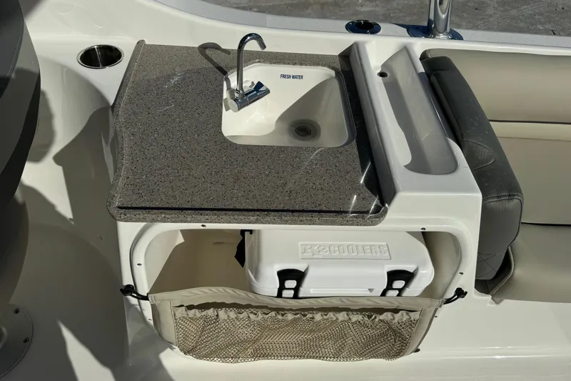 Slide: The Image of Key West 239 DFS 2025 boat sink with cooler storage and seating area. - 18