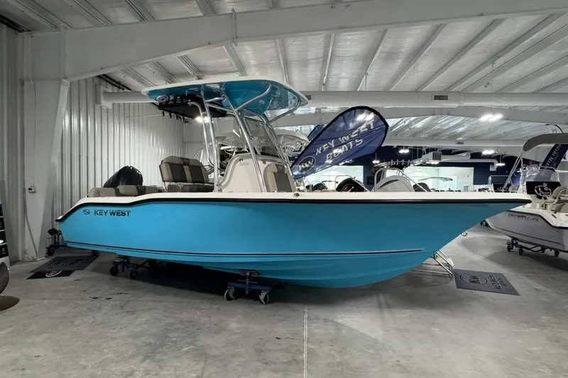 The Image of 2026 Key West 219 FS boat in showroom, vibrant blue hull, modern design. - 1
