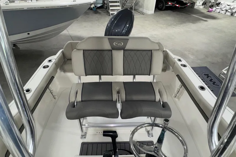 Slide: The Image of 2026 Key West 219 FS boat interior with dual seating and steering wheel. - 13