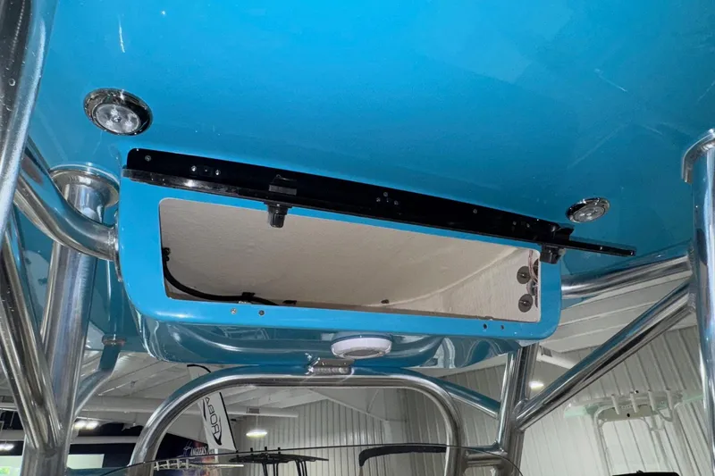 Slide: The Image of 2026 Key West 219 FS boat interior, featuring a blue overhead compartment and stainless steel supports. - 16