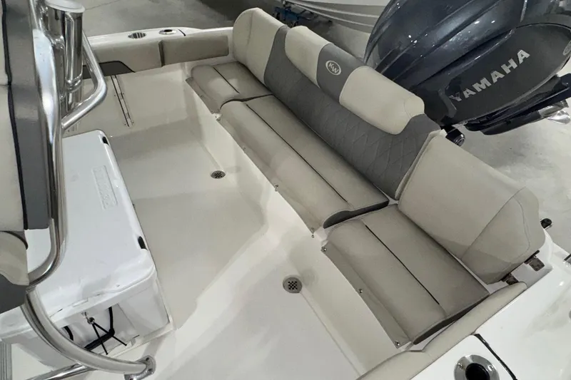 Slide: The Image of 2026 Key West 219 FS boat interior with cushioned seating and Yamaha engine. - 17