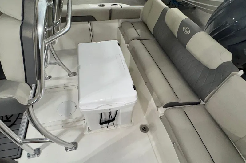 Slide: The Image of 2026 Key West 219 FS boat interior with cushioned seating and a white cooler. - 18