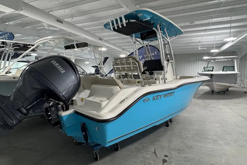 Slide: The Image of 2026 Key West 219 FS boat with Yamaha engine in showroom. - 2