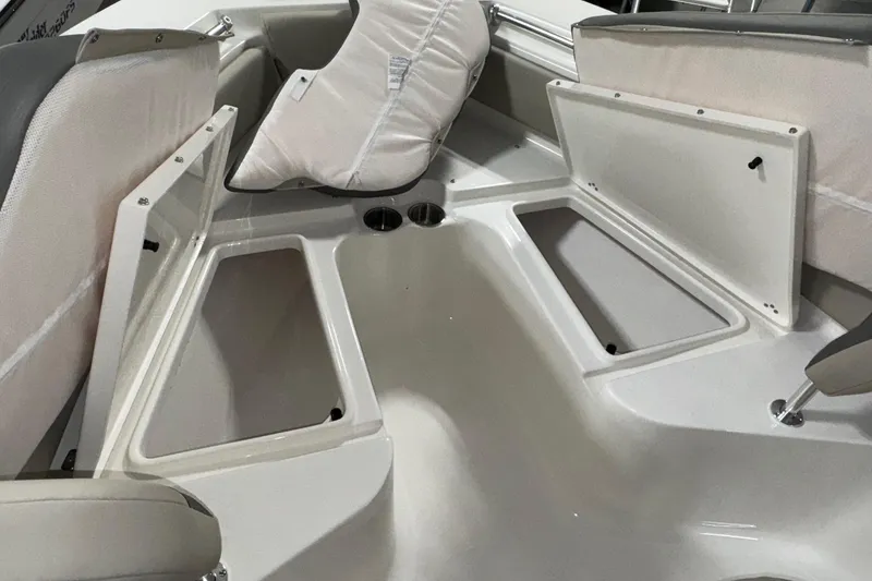 Slide: The Image of 2026 Key West 219 FS boat interior with open storage compartments and seating. - 10