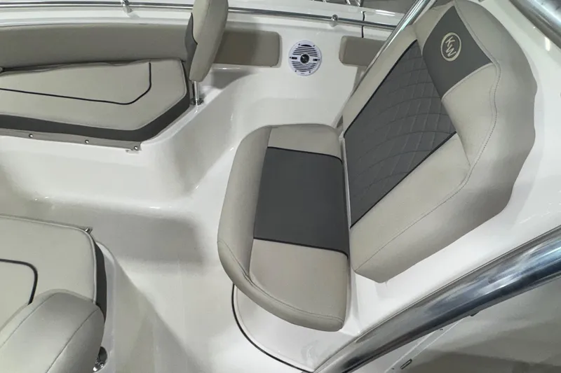 Slide: The Image of 2026 Key West 219 FS boat interior with cushioned seating and speaker. - 11