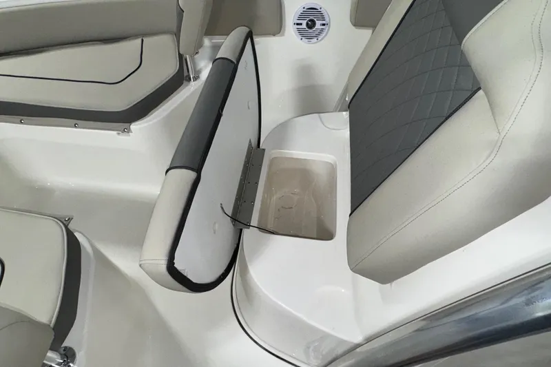 Slide: The Image of 2026 Key West 219 FS boat interior with open storage compartment and cushioned seating. - 12