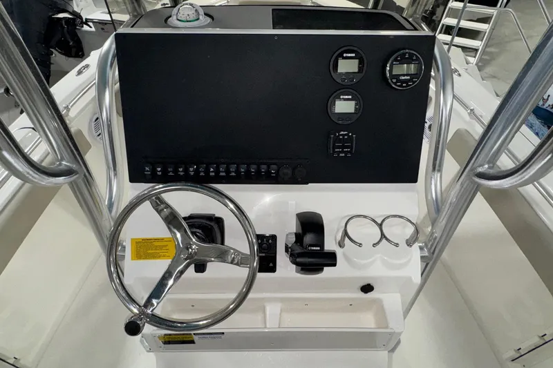 Slide: The Image of 2026 Key West 219 FS boat console with steering wheel and control panel. - 15