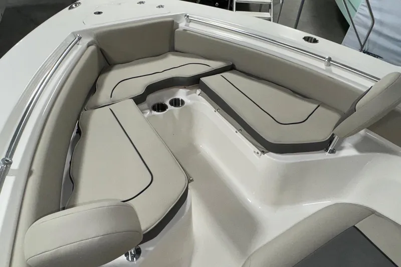 Slide: The Image of 2026 Key West 219 FS boat interior with cushioned seating and cup holders. - 9