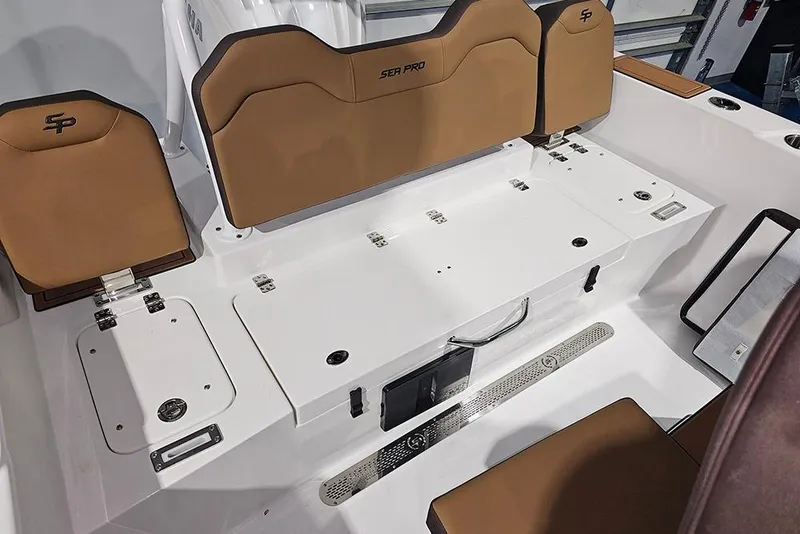 Slide: The Image of 2026 Sea Pro 245FLX Sandbar boat interior with tan seating and storage compartments. - 12