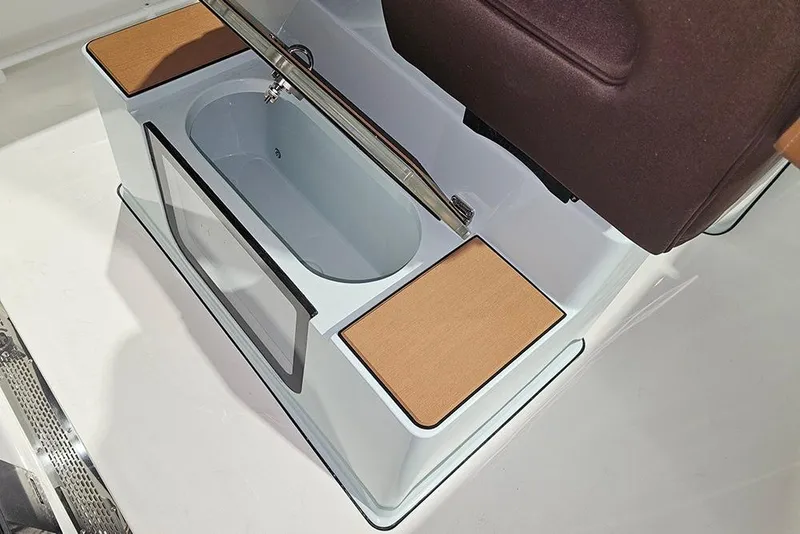 Slide: The Image of 2026 Sea Pro 245FLX Sandbar boat interior with storage compartment and cushioned seating. - 16