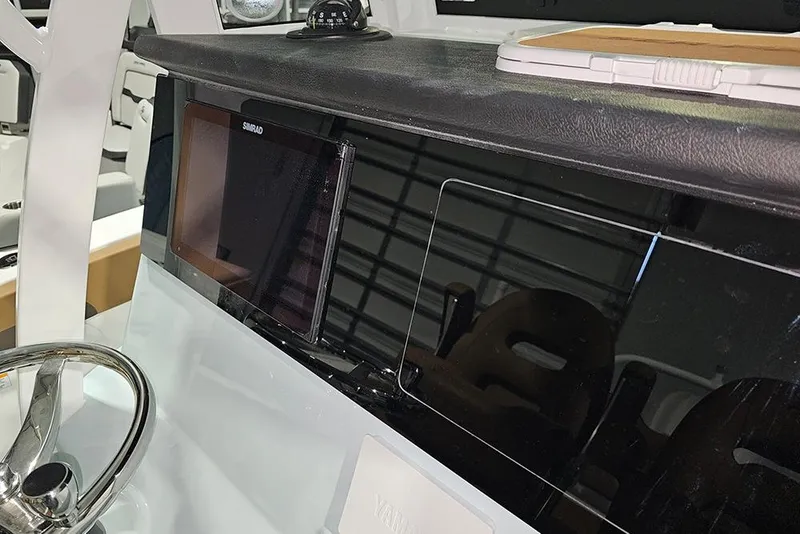 Slide: The Image of 2026 Sea Pro 245FLX Sandbar dashboard with Simrad display and steering wheel. - 21