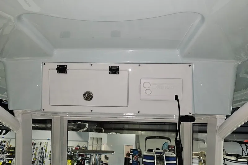 Slide: The Image of 2026 Sea Pro 245FLX Sandbar boat console with storage compartments and controls. - 23