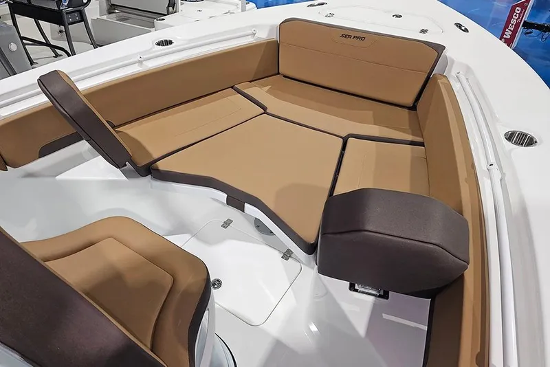 Slide: The Image of 2026 Sea Pro 245FLX Sandbar boat interior with tan and brown cushioned seating. - 28