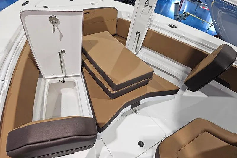 Slide: The Image of 2026 Sea Pro 245FLX Sandbar boat interior with tan seating and storage compartments. - 29
