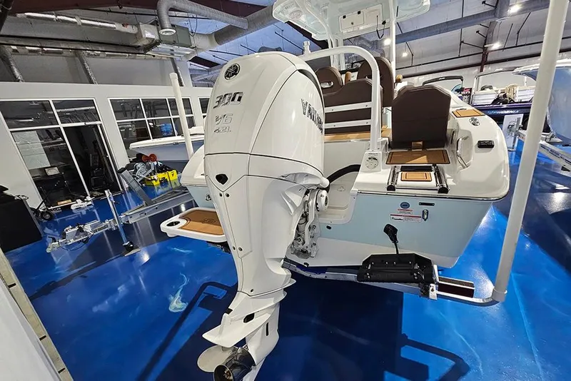 Slide: The Image of 2026 Sea Pro 245FLX Sandbar boat with powerful outboard motor in showroom. - 6