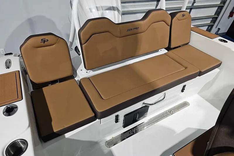 Slide: The Image of 2026 Sea Pro 245FLX Sandbar boat seating with tan cushions and storage compartments. - 7