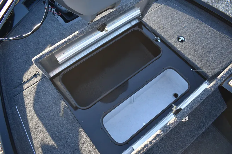 Slide: The Image of 2026 Lowe Stinger 175C boat storage compartments with open lids, showcasing interior design. - 11
