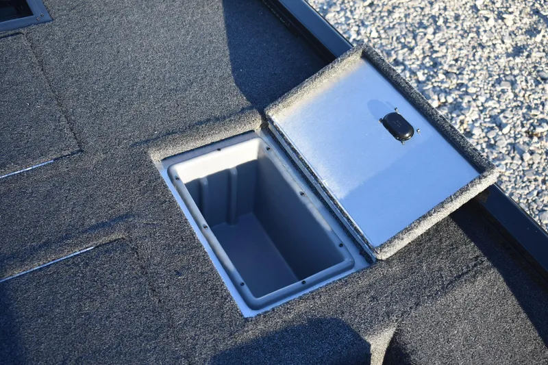 Slide: The Image of Open storage compartment on 2026 Lowe Stinger 175C boat deck. - 12
