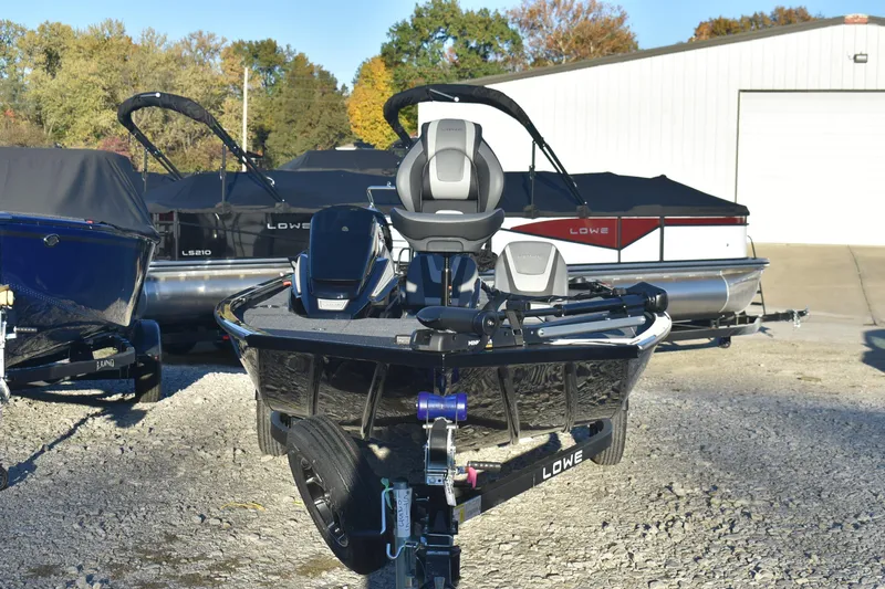 Slide: The Image of 2026 Lowe Stinger 175C fishing boat displayed outdoors, surrounded by other boats. - 3