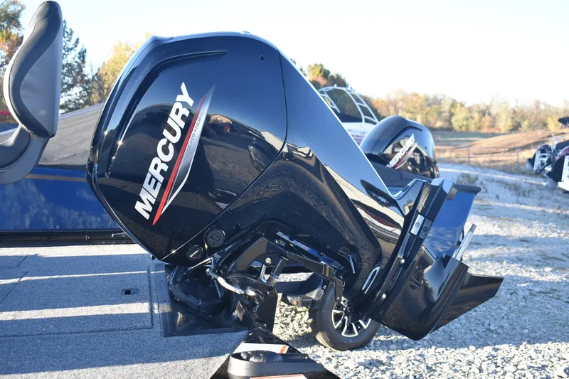 Slide: The Image of 2026 Lowe Stinger 175C with Mercury outboard motor, parked outdoors on gravel. - 5