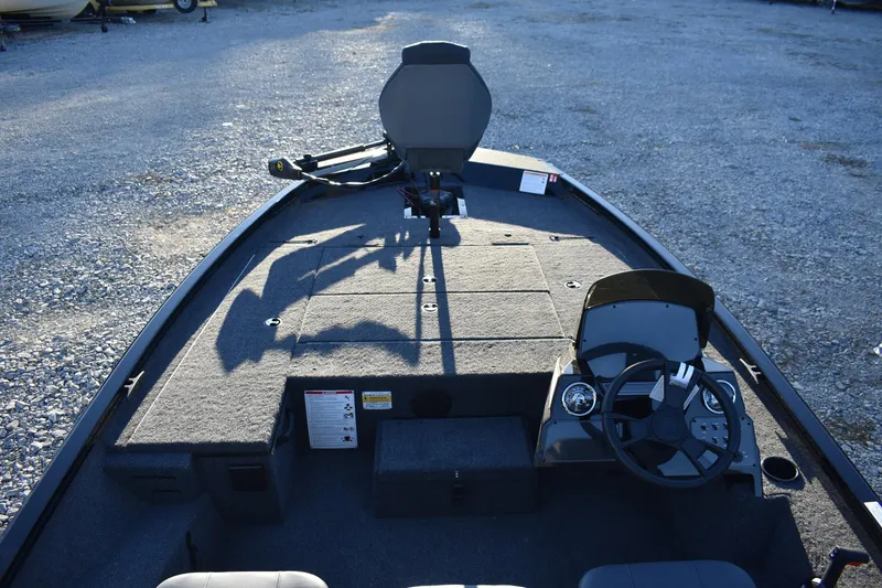 Slide: The Image of 2026 Lowe Stinger 175C boat interior with steering wheel and seating. - 6