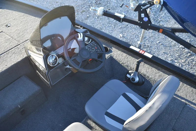 Slide: The Image of 2026 Lowe Stinger 175C boat cockpit with steering wheel and control panel. - 7