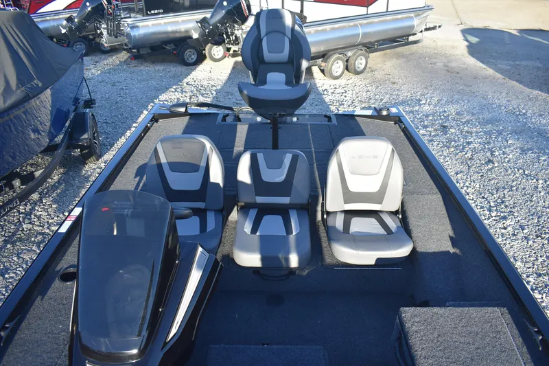 Slide: The Image of 2026 Lowe Stinger 175C boat interior with seating and motor, displayed outdoors. - 9