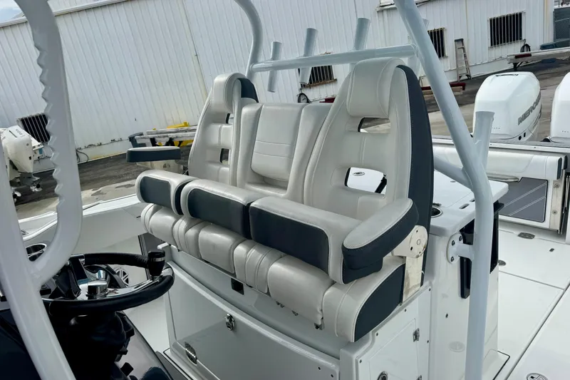 Slide: The Image of 2023 Blackfin 332 CC boat interior with dual captain's chairs and steering wheel. - 100