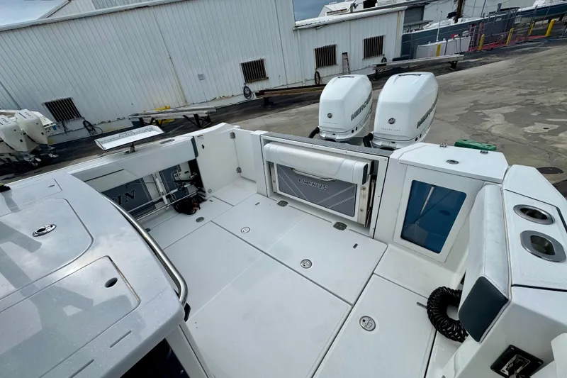 Slide: The Image of 2023 Blackfin 332 CC boat with dual Mercury engines at a dock. - 103