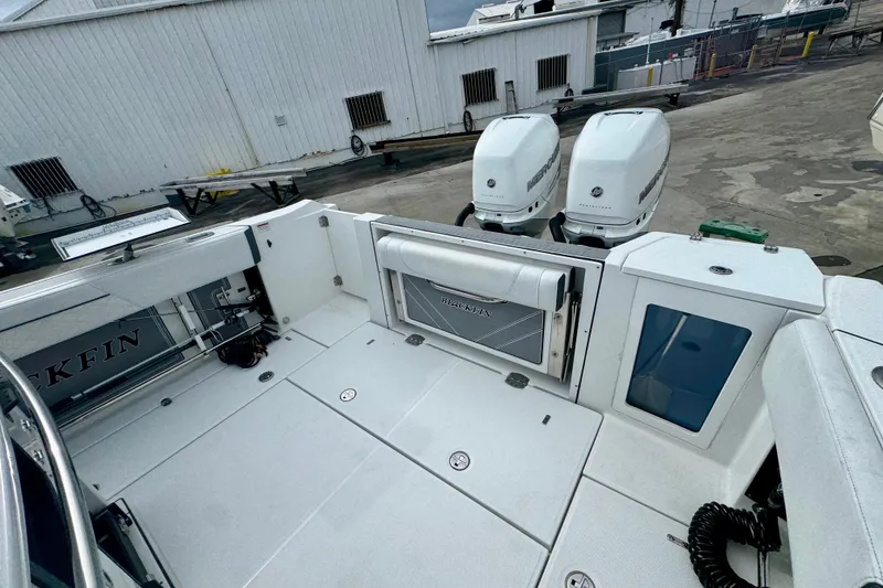 Slide: The Image of 2023 Blackfin 332 CC boat with dual Mercury engines at a dock. - 104