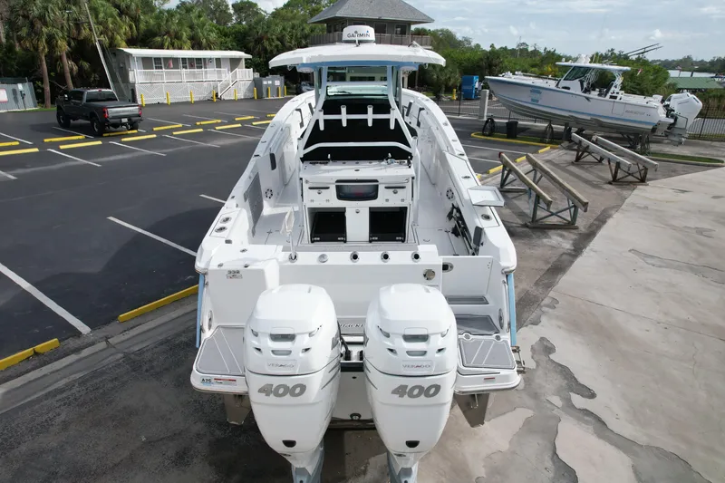 Slide: The Image of 2023 Blackfin 332 CC boat with dual 400 horsepower engines in a marina setting. - 13