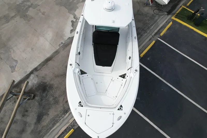 Slide: The Image of 2023 Blackfin 332 CC boat, aerial view, docked on concrete surface. - 21
