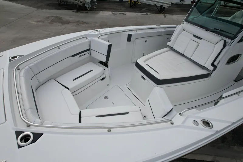 Slide: The Image of 2023 Blackfin 332 CC boat interior with white cushioned seating and sleek design. - 34