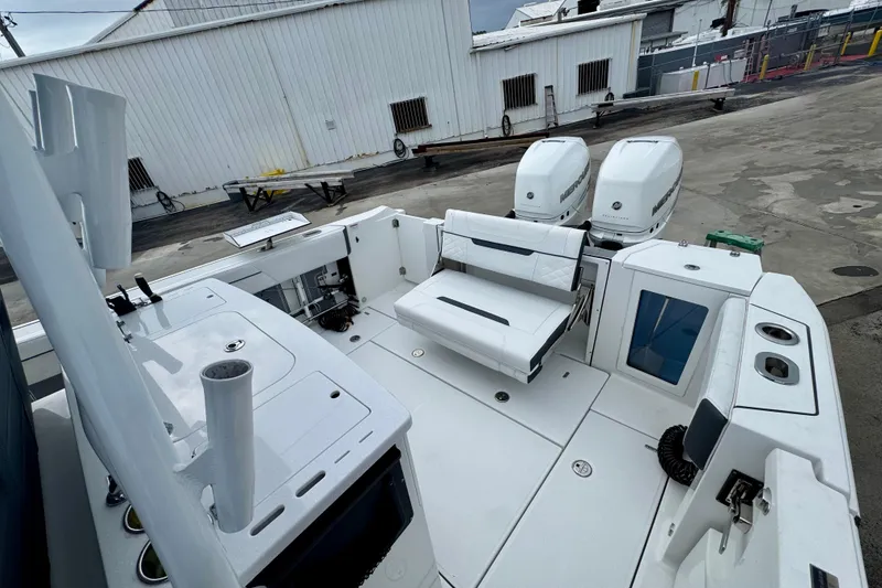 Slide: The Image of 2023 Blackfin 332 CC boat interior with dual Mercury engines and seating area. - 60