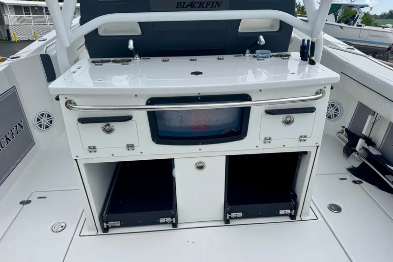 Slide: The Image of 2023 Blackfin 332 CC boat interior with storage compartments and fishing station. - 65