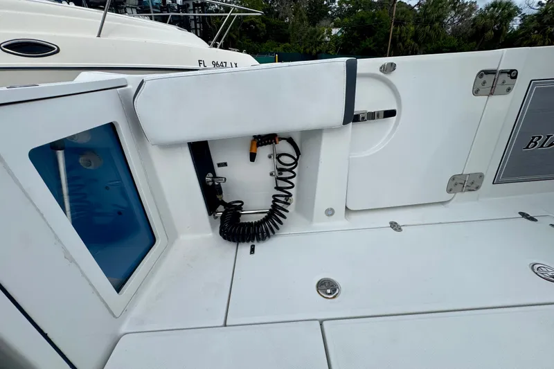 Slide: The Image of 2023 Blackfin 332 CC boat deck with storage and coiled cable. - 70