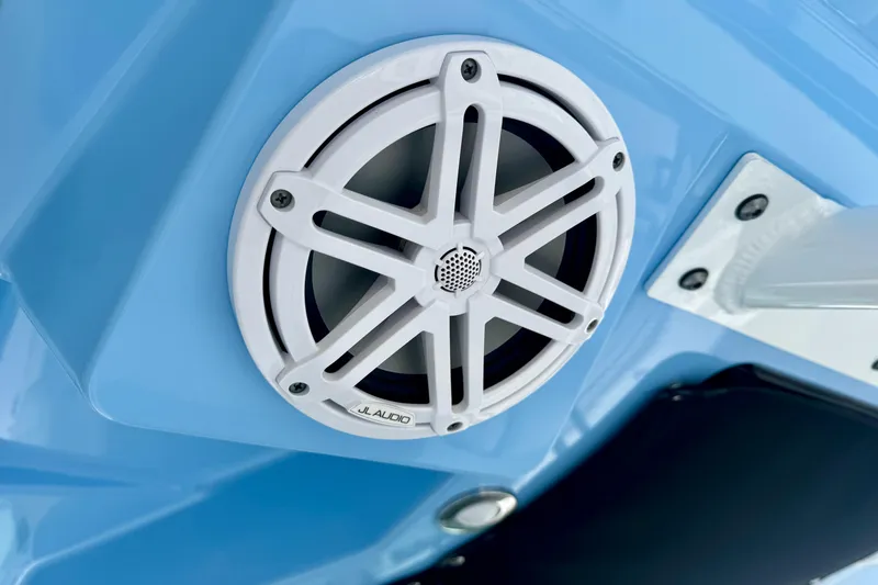 Slide: The Image of White JL Audio speaker on 2023 Blackfin 332 CC boat, mounted on blue surface. - 73