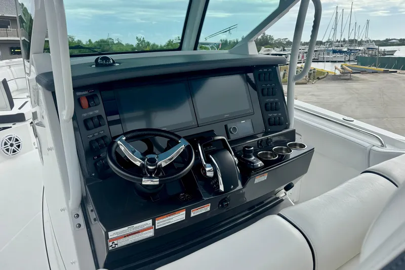 Slide: The Image of 2023 Blackfin 332 CC boat helm with modern controls and navigation system. - 74