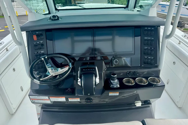 Slide: The Image of 2023 Blackfin 332 CC helm with dual screens, steering wheel, and control panel. - 75