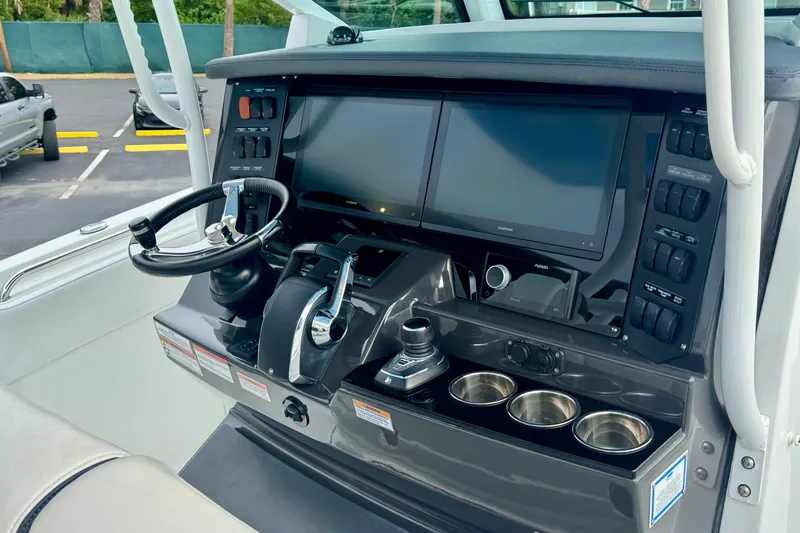 Slide: The Image of 2023 Blackfin 332 CC helm with dual screens and modern controls. - 77