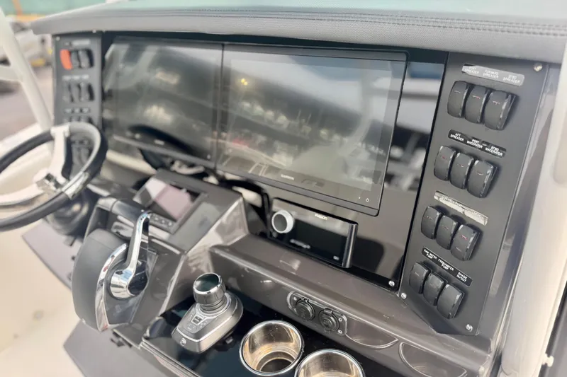 Slide: The Image of 2023 Blackfin 332 CC boat dashboard with advanced controls and touchscreen display. - 80