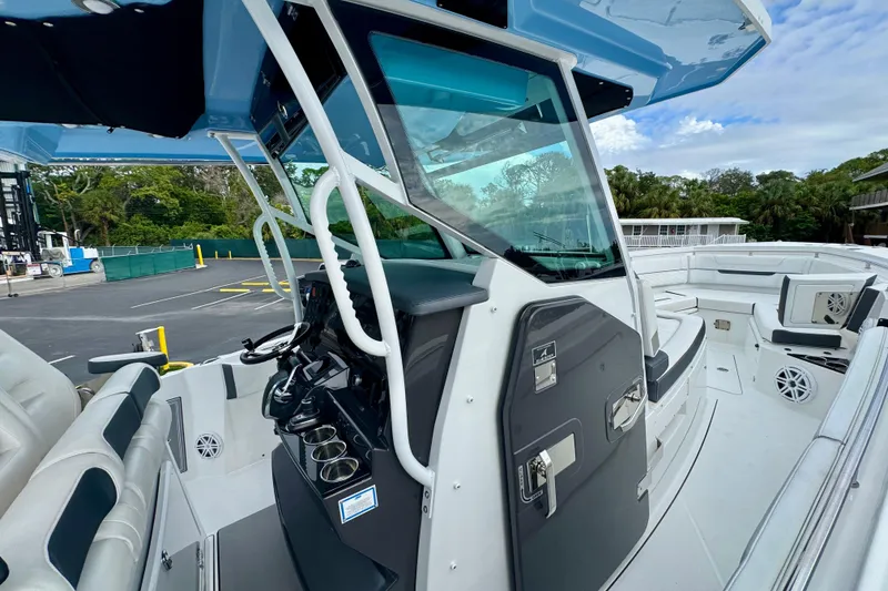 Slide: The Image of 2023 Blackfin 332 CC boat interior with modern helm and seating area. - 82