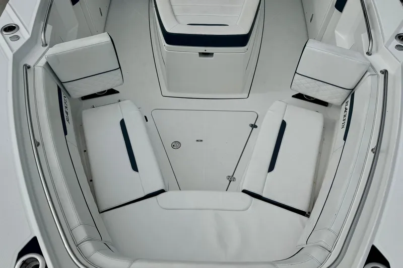 Slide: The Image of 2023 Blackfin 332 CC boat interior with white cushioned seating and storage compartments. - 91