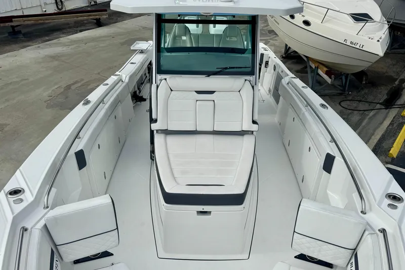 Slide: The Image of 2023 Blackfin 332 CC boat interior with white seating and spacious deck layout. - 92