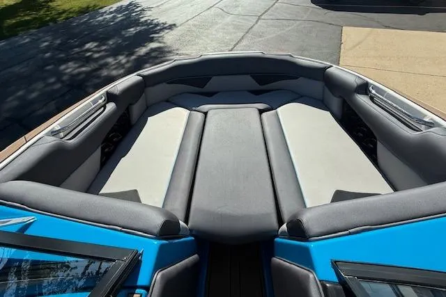 Slide: The Image of 2020 Moomba Makai boat interior with gray seating and blue accents. - 14