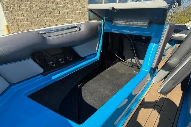 Slide: The Image of 2020 Moomba Makai boat interior storage compartment with blue and gray seating. - 16