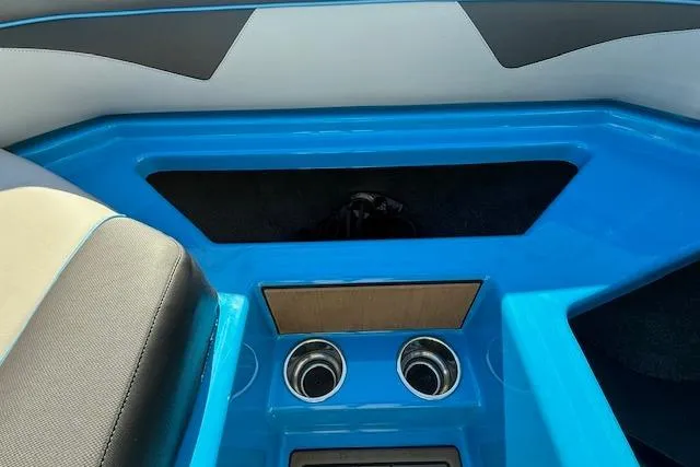Slide: The Image of 2020 Moomba Makai boat interior with blue accents and cup holders. - 17