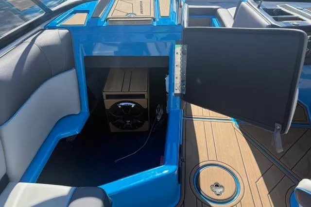 Slide: The Image of 2020 Moomba Makai boat interior with open storage compartment and speaker system. - 19