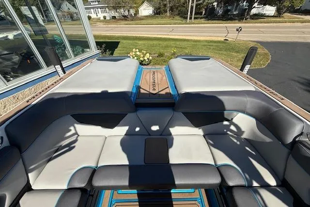 Slide: The Image of 2020 Moomba Makai boat interior with gray seating and blue accents. - 23